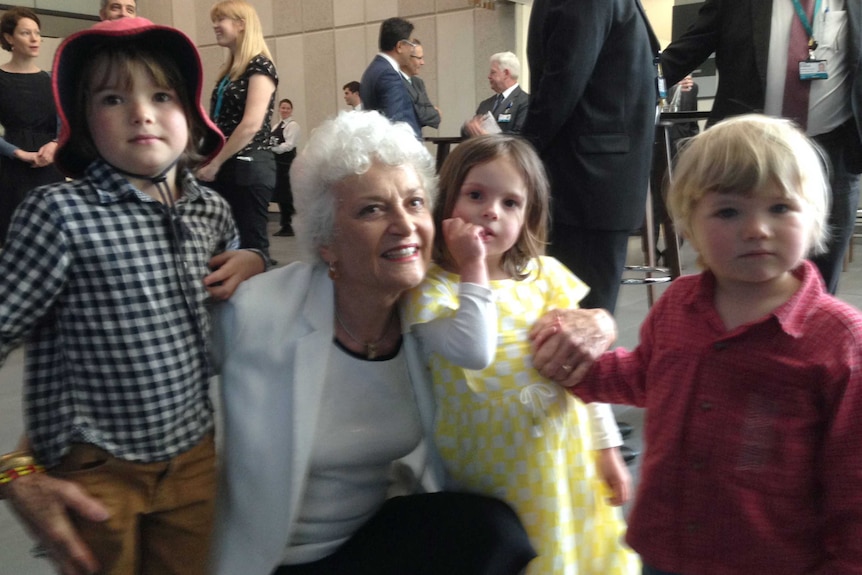 Kneeling on the ground is Professor Fiona Stanley with children at the opening of the hospital named after her, in Perth