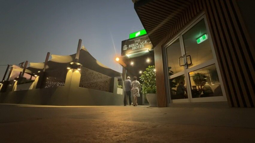 two people walk into hotel in Longreach