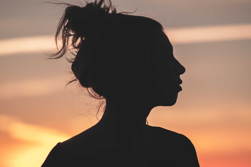 A woman in silhouette.