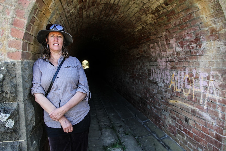Creator of the performance Light at the End, Rose Turtle Ertler standing at the entrance to the railway tunnel.
