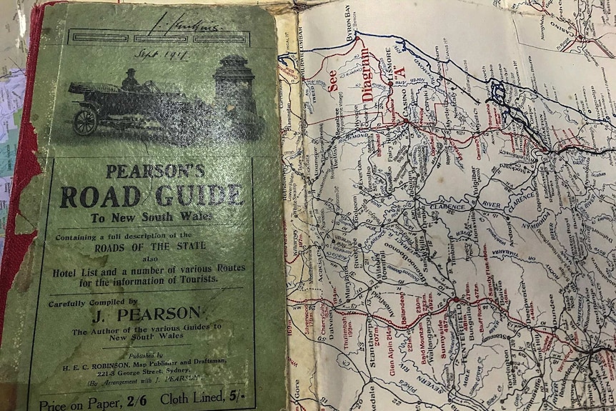Close up of the front cover and folded out page of an old map from 1917 showing roads around NSW.
