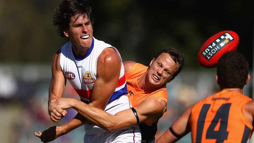 James McDonald tries to rein in midfield star Ryan Griffen.