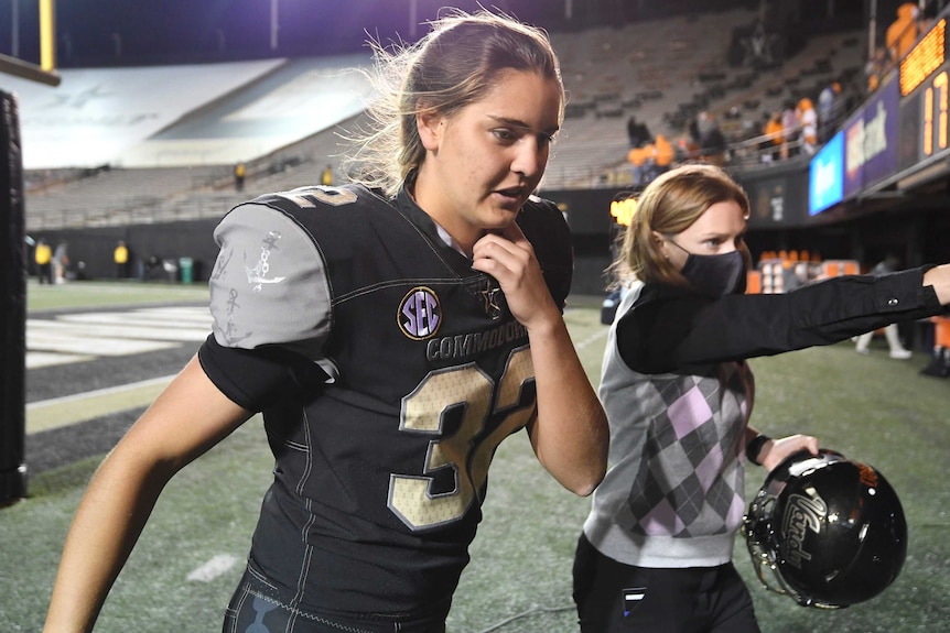 A Vanderbilt University female place kicker leaves the field after a US college football game.