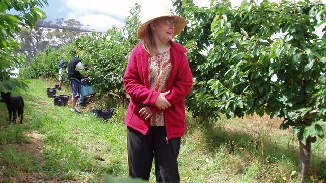 Amy Gallasch standing among fruit trees