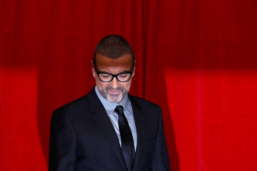 George Michael poses for photographers before a news conference in London, 2011.