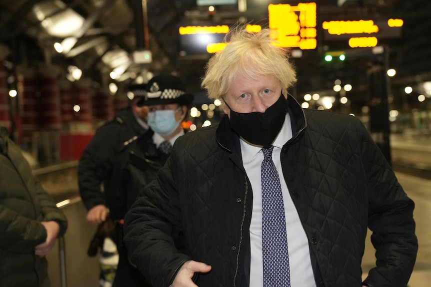 British Prime Minister Boris Johnson wears a face mask