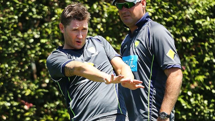 Michael Clarke (left) trains while Mickey Arthur looks on