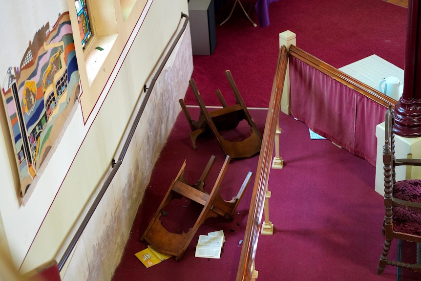 Broken chairs and bibles on the flood at the Wesley Uniting Church in Broken Hill