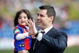 Former Newcastle Knights player James McManus with his daughter Evelyn at Hunter Stadium in Newcastle.