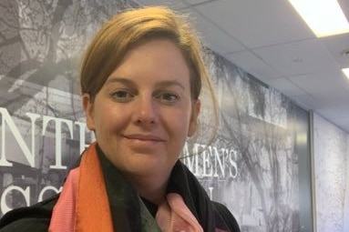 Woman smiling with colourful scarf around her neck