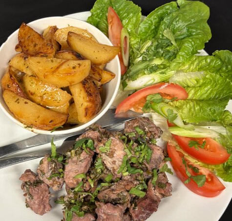 Pork, potatoes and salad on a plate