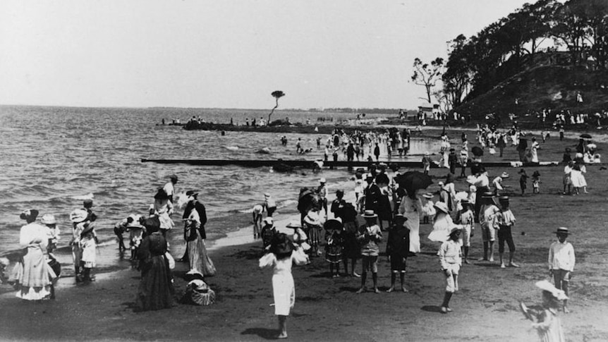 People on a beach in 1920.