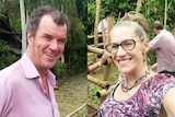 A diptych of a man and woman in pink and purple garments look into the camera in front of a verdant backdrop.