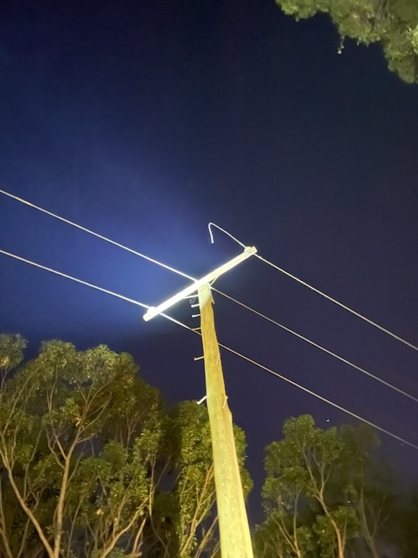 A power police with three wires, one of which has been cut.