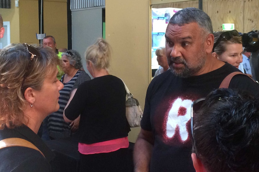 Man speaks with two women