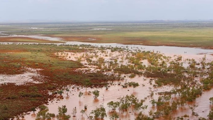 An aerial shot of land under water following a cyclone