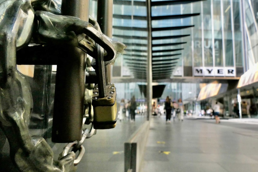 A heavy padlock around the doors of a shopfront in Melbourne CBD.