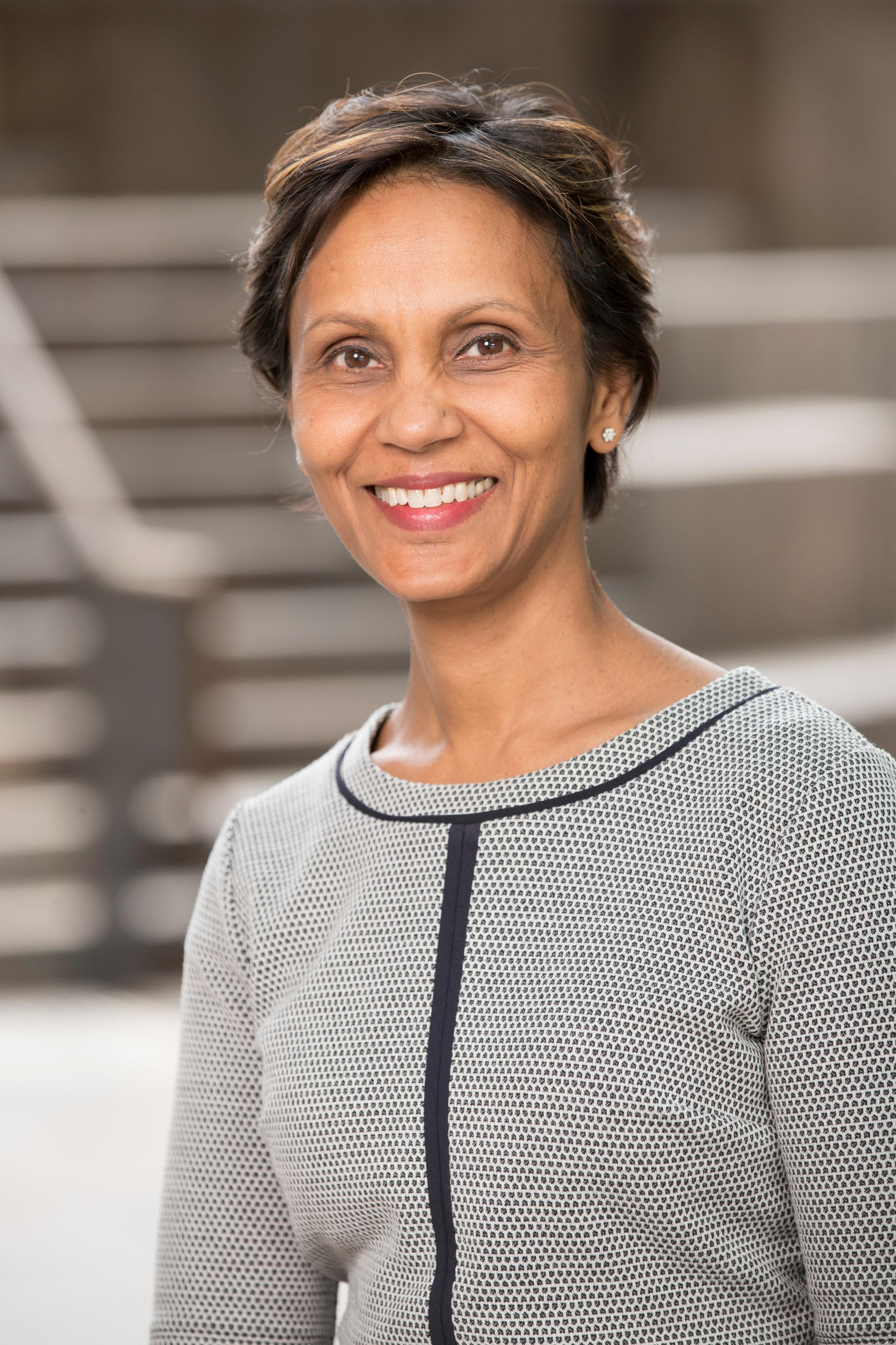 A headshot of a woman smiling at the camera