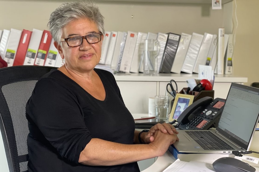 Angela Sdrinis at her desk