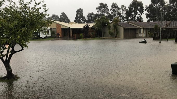 Floodwater over a road near a house