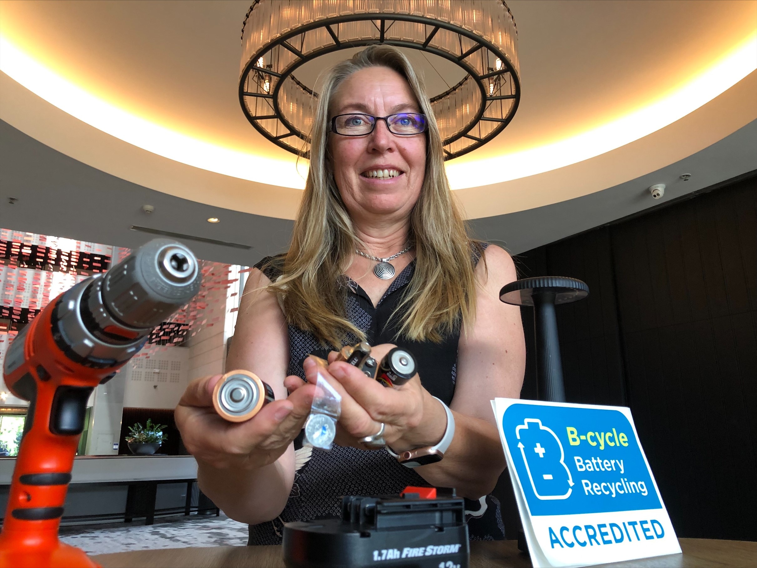 a woman holding batteries in her hands