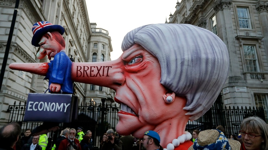 Theresa May effigy passes Downing Street during march