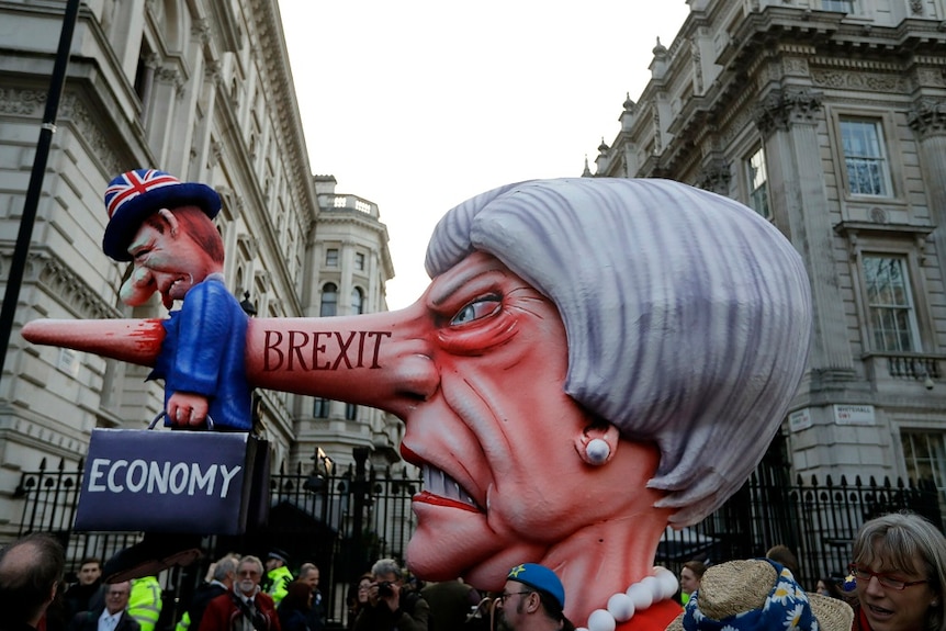 Theresa May effigy passes Downing Street during march