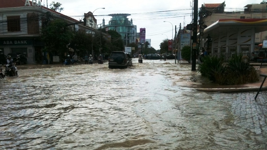 Floodwaters cover a road in Cambodia