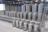 Small to very large stainless steel tanks inside a new winery at Penna.