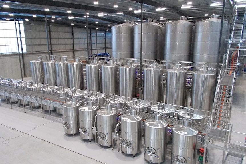 Small to very large stainless steel tanks inside a new winery at Penna.