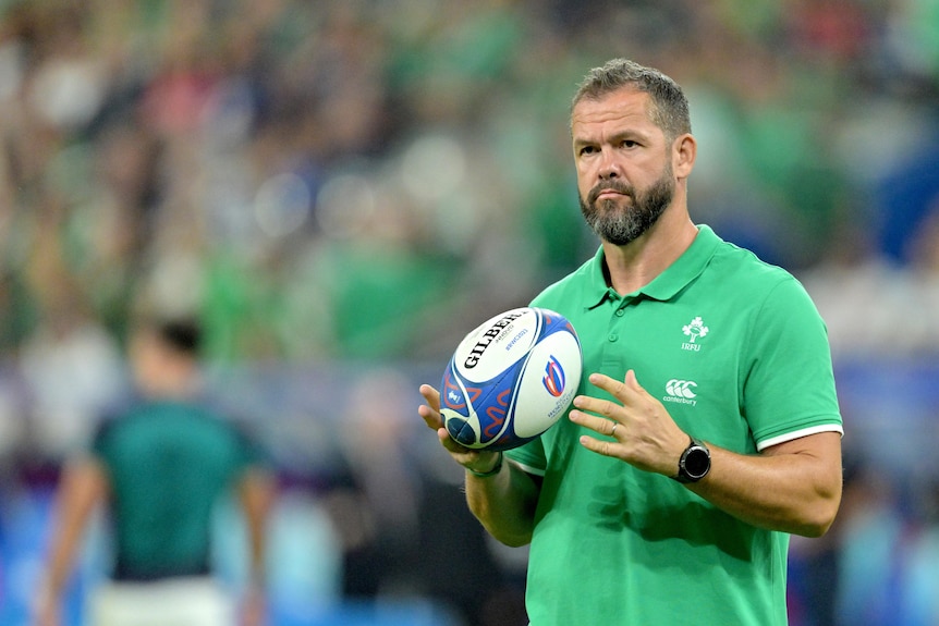 Andy Farrell holds a rugby ball