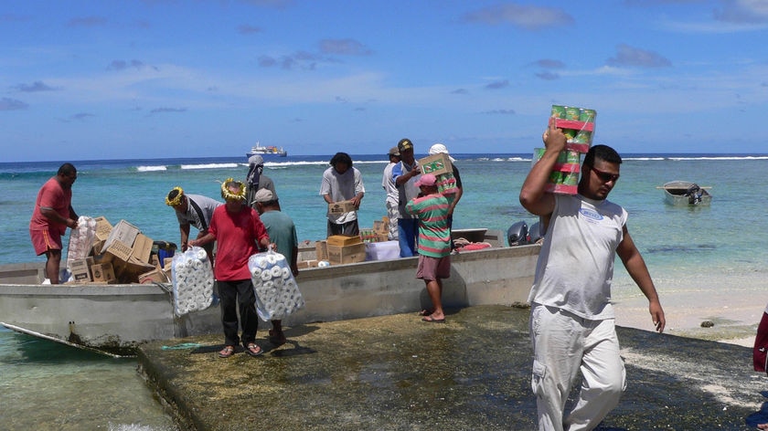 Tokelau islanders unload supply barge
