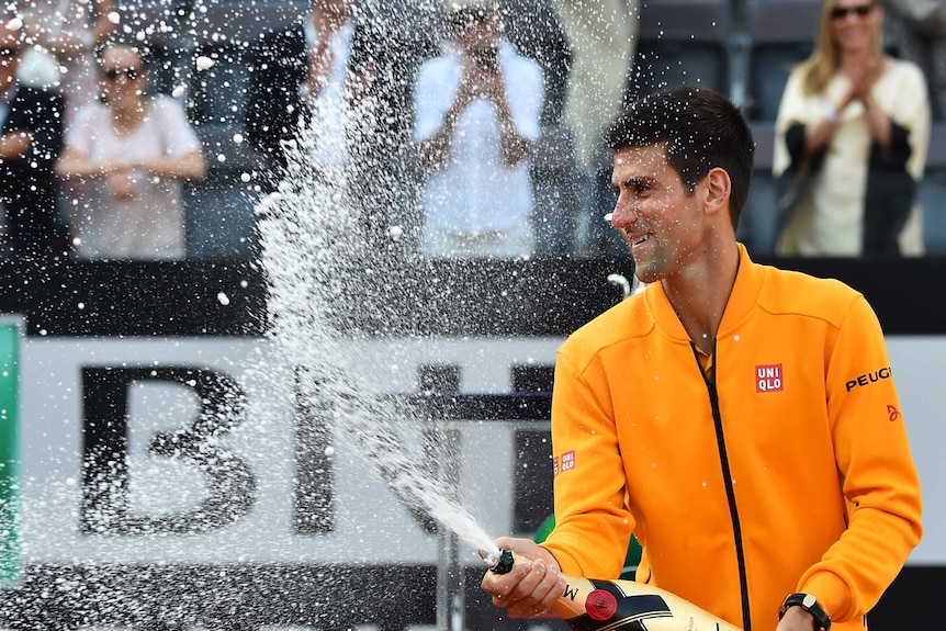 Novak Djokovic sprays champagne after winning the Rome Masters