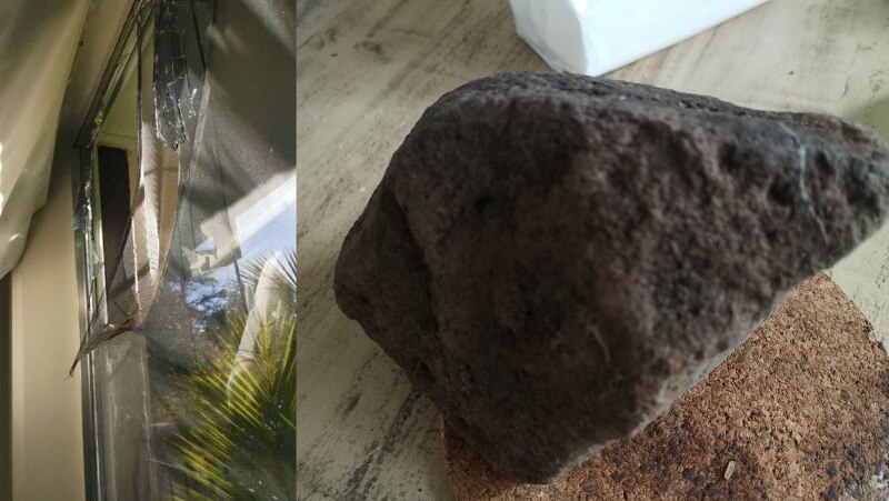 A broken window is shown on the left in this composite image, and a large rock is shown on a coaster on a table on the right.