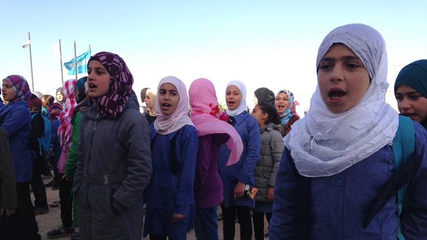 Children line up at the Bahrain funded school in Zaatari camp.