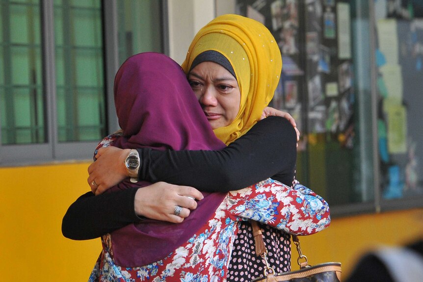 Family members in Singapore mourn earthquake victims