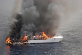 Flames pour from the luxury yacht, the Seafaris, after it caught on fire.