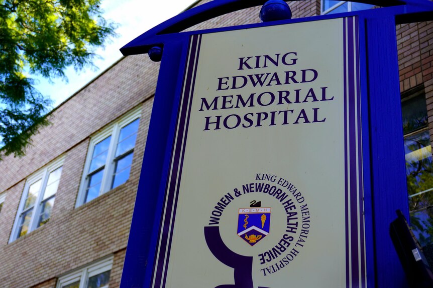 A close-up of a blue and white sign outside King Edward Memorial Hospital.
