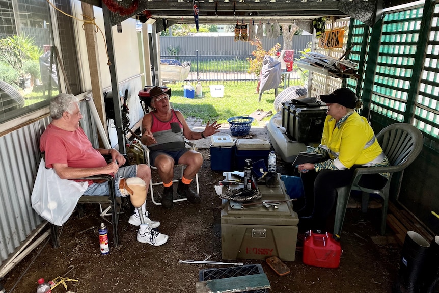 Local woman sitting and talking to holiday park residents