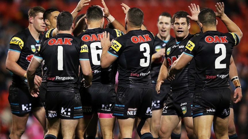 Penrith players celebrate a try against Brisbane on August 23, 2013.