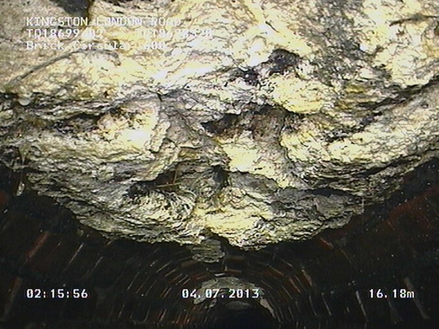 A congealed 15-tonne 'fatberg' hangs from the roof of a London sewer.