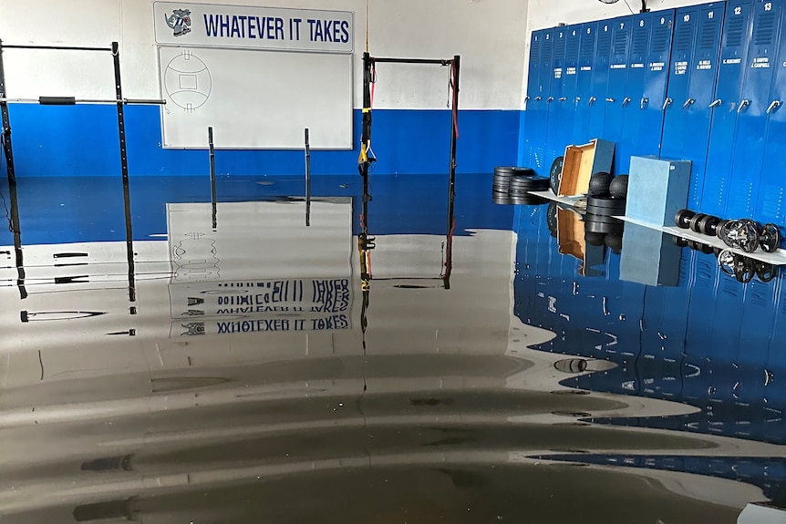 A blue and white footy changeroom, half underwater
