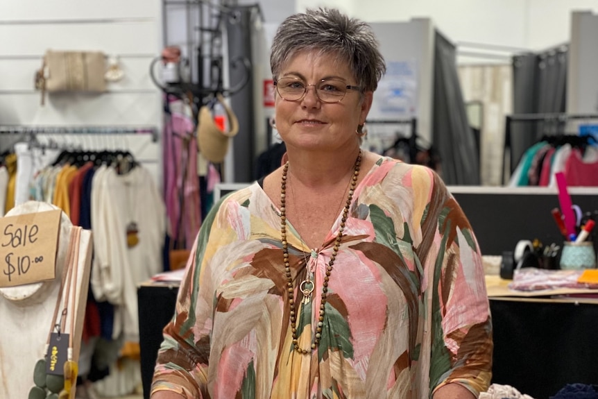 A shop owner in a clothing store.