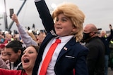 Supporters, including a child in a Trump costume, cheer as President Donald Trump arrives to speak at a campaign rally