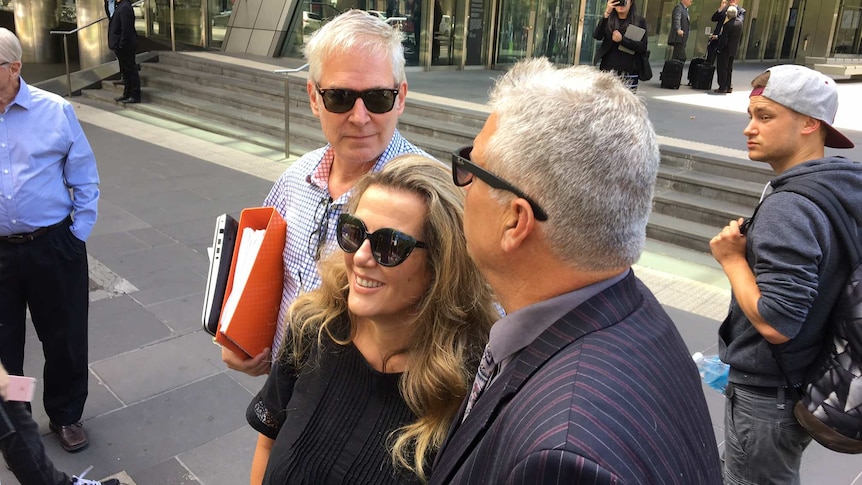 Michael Lawler, Kathy Jackson and a supporter leave court