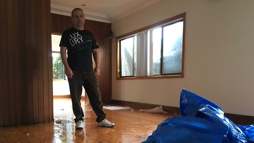 Steve Wilson cleans up his home in Kurnell after storm