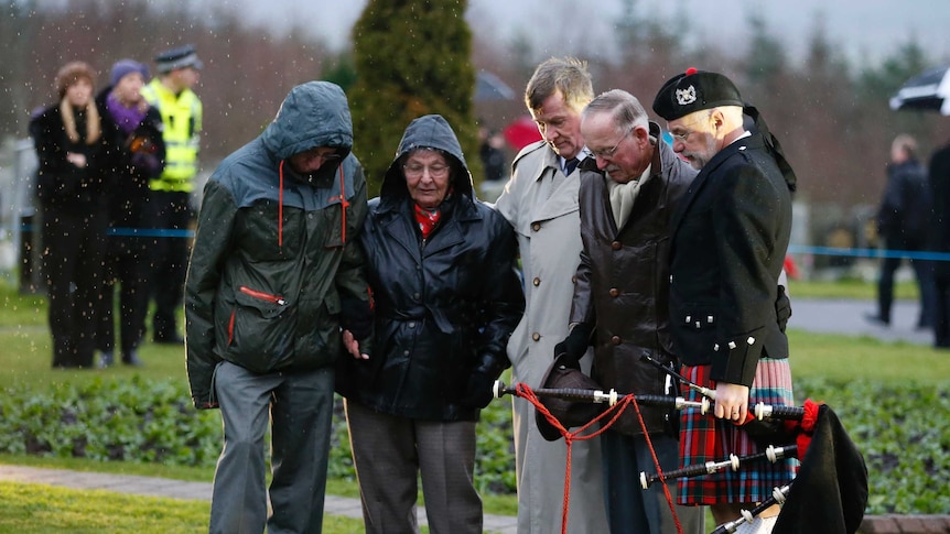 The parents of Lockerbie bombing victim Patricia Ann Klein look at a memorial in Scotland's Dryfesdale Cemetery.