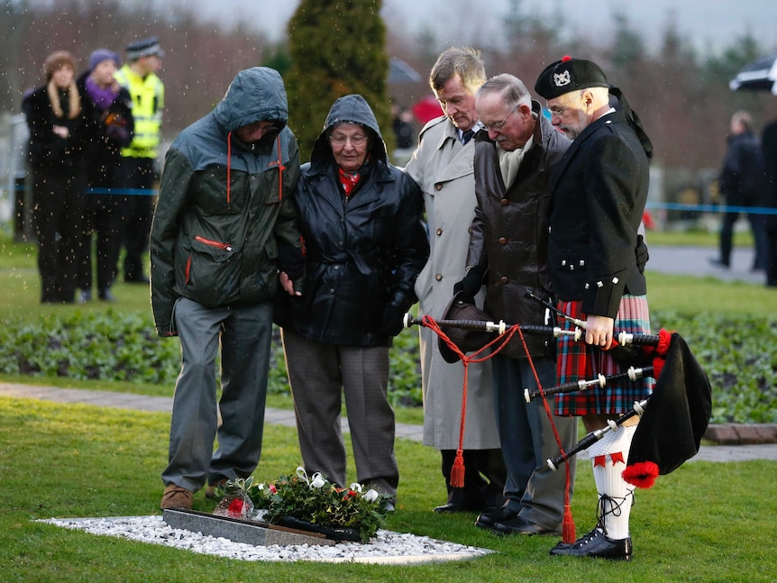 The parents of Lockerbie bombing victim Patricia Ann Klein look at a memorial in Scotland's Dryfesdale Cemetery.