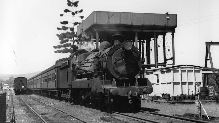 Steam train going through station