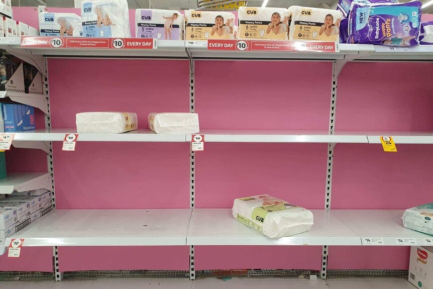 A row on pink shelves is largely empty, with few nappies left.
